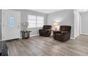 Bright living room with two brown recliner chairs and hardwood floors at 4526 101St N Ave, Pinellas Park, FL 33782