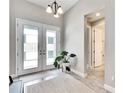 Bright entryway with double doors and tile flooring at 5612 Limelight Dr, Apollo Beach, FL 33572