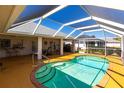 Relaxing pool area with covered patio and outdoor seating at 72 Norman St, Port Charlotte, FL 33954