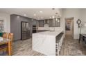 Updated kitchen boasts stainless steel appliances and a large island with seating at 735 Bonnie Blvd, Palm Harbor, FL 34684