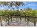 Wooden dock overlooking a calm waterway, perfect for relaxing at 8703 Driftwood Dr, Tampa, FL 33615