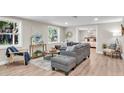 Bright living room featuring a comfy sectional sofa and large windows at 11416 Pine Forest Dr, New Port Richey, FL 34654