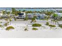 Aerial view of a beach house community with a beautiful beach at 1205 Gulf Way, St Pete Beach, FL 33706