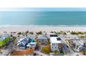 Aerial view of beach houses, the beach, and ocean at 1205 Gulf Way, St Pete Beach, FL 33706