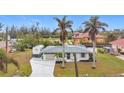 Single story home with spacious driveway and lush landscaping at 141 Singapore Rd, Punta Gorda, FL 33950