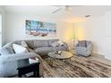 Bright and airy living room featuring comfy seating and a large TV at 141 Singapore Rd, Punta Gorda, FL 33950