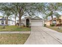 Two-story house with a driveway and front yard at 18452 Merseyside Loop, Land O Lakes, FL 34638