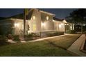 Well-lit villa at night, landscaped grounds, walkway at 2071 Sifield Greens Way # 103, Sun City Center, FL 33573