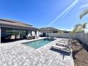 Inviting pool and spa with lounge chairs, surrounded by a paved patio at 3013 61St E Dr, Ellenton, FL 34222
