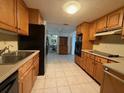 Bright kitchen, with wood cabinets and view to dining area at 3090 Arrowhead Rd, Venice, FL 34293