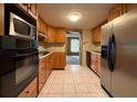 Galley-style kitchen with wood cabinets and appliances at 3090 Arrowhead Rd, Venice, FL 34293