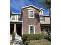 Two-story townhome with stone facade and lush landscaping at 31247 Claridge Pl, Wesley Chapel, FL 33543