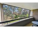 Balcony view of lush green trees and landscape at 36750 Us Highway 19 # 24209, Palm Harbor, FL 34684