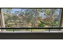 Balcony view of lush green trees and landscape at 36750 Us Highway 19 # 24209, Palm Harbor, FL 34684