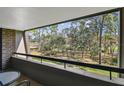 Balcony view of lush green trees and landscape with seating at 36750 Us Highway 19 # 24209, Palm Harbor, FL 34684
