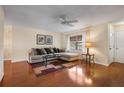 Living room with hardwood floors, sectional sofa, and ceiling fan at 537 5Th Se St, Largo, FL 33771