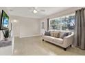 Living room features hardwood floors, large windows, and a comfy sofa at 7095 17Th N Way, St Petersburg, FL 33702