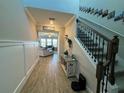 Bright and spacious entryway with a staircase and view into the living room at 8365 Capstone Ranch Dr, New Port Richey, FL 34655
