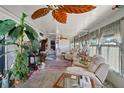 Bright sunroom features comfy seating, large windows, and ceiling fan at 9790 66Th N St # 130, Pinellas Park, FL 33782