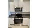 Modern kitchen with stainless steel appliances and granite countertops at 840 Tennyson Mill Cir, Tampa, FL 33619