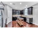 Modern kitchen featuring dark wood cabinets and stainless steel appliances at 10409 Waterstone Dr, Riverview, FL 33578