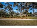 Ranch style brick home with lush lawn and mature shade trees at 118 Laurel Tree Way, Brandon, FL 33511