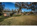 Brick home with mature landscaping and a large yard at 118 Laurel Tree Way, Brandon, FL 33511