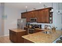 Spacious kitchen featuring granite countertops and stainless steel appliances at 1922 Echo Pond Pl, Wesley Chapel, FL 33543