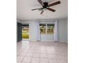Bright living room featuring tile floors and ceiling fan at 235 Se Madison N Cir, St Petersburg, FL 33703