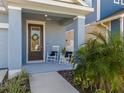 Front porch with rocking chairs and landscaping at 28818 Orange Berry Dr, Wesley Chapel, FL 33543