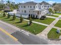 Spacious two-story home with a well-manicured lawn and a white picket fence at 323 Appian Ne Way, St Petersburg, FL 33704