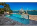Inviting heated pool with patio and boat dock view at 366 La Hacienda Dr, Indian Rocks Beach, FL 33785