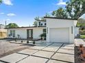 Contemporary house with white exterior, grey driveway, and a two-car garage at 513 Hand Ave, Sarasota, FL 34232