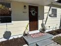 Welcoming front door with wreath and potted plants at 5517 12Th Ave S, Gulfport, FL 33707