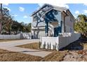 Two-story house with gray and blue exterior, white fence, and a paved driveway at 7321 Mount Vernon Rd, Tampa, FL 33625