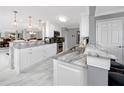 Bright kitchen featuring white cabinets and marble countertops at 8186 Terrace Garden N Dr # 609, St Petersburg, FL 33709