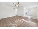 Open living room with kitchen access and hardwood floors at 8719 92Nd Ter, Seminole, FL 33777