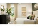 Bright bedroom with a large window and dresser at 9382 Runaway Breeze Dr, Land O Lakes, FL 34637