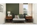 Bedroom with crib, nightstands, and green accent wall at 11555 E 71St Ter, Palmetto, FL 34221
