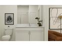 Modern bathroom with white vanity, toilet and a walk in shower at 11562 E 71St Ter, Palmetto, FL 34221