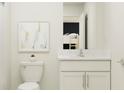 Simple bathroom with white vanity and toilet, plus a shower at 11915 Blue Diamond Trl, Parrish, FL 34219
