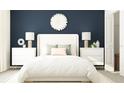 Bedroom with white bed, nightstands, and a dark blue accent wall at 11915 Blue Diamond Trl, Parrish, FL 34219