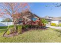 Landscaped front yard with mature trees and shrubs at 12312 Bay Estuary Bnd, Riverview, FL 33579