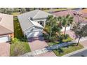 One-story house with a tiled roof and brick driveway, seen from above at 15724 Aurora Lake Cir, Wimauma, FL 33598
