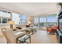 Bright living room with comfy seating, large windows, and balcony access at 17717 Gulf Blvd # 601, Redington Shores, FL 33708