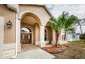 Double-door entry with arched entryway and tile flooring at 1833 Hillcrest St, Tarpon Springs, FL 34689