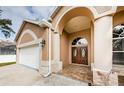 House exterior with double doors and a two-car garage at 1833 Hillcrest St, Tarpon Springs, FL 34689