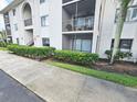 Condo building exterior with landscaping and walkway at 2067 Hunters Glen Dr # 313, Dunedin, FL 34698