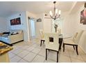 Dining area with glass table and four chairs at 2067 Hunters Glen Dr # 313, Dunedin, FL 34698