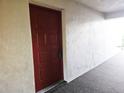 Red front door entrance to condo unit at 2067 Hunters Glen Dr # 313, Dunedin, FL 34698